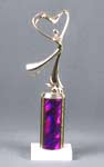 This is a image of a small trophy with modern dance figure on a purple column on a white marble base